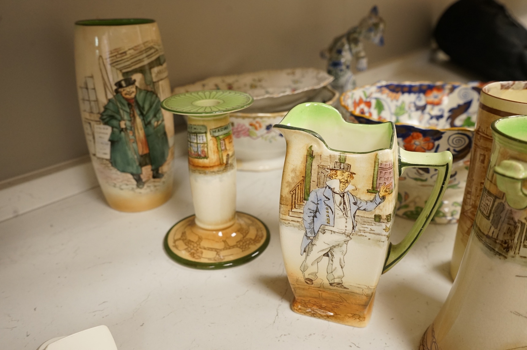 A collection of French, Japanese and English ceramics to include Royal Doulton Dickensware, Imari bowls and a faience glazed cat